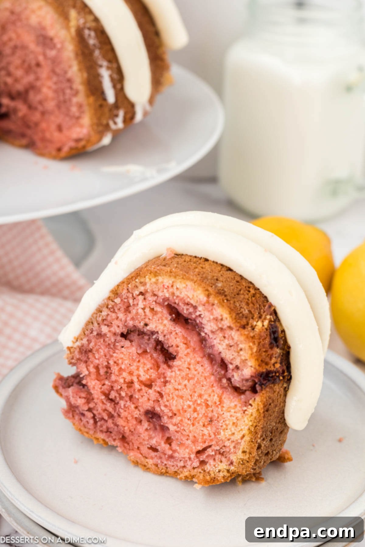 Zesty Strawberry Lemon Bundt Delight 9 Strawberry lemonade bundt cake sliced on plate.