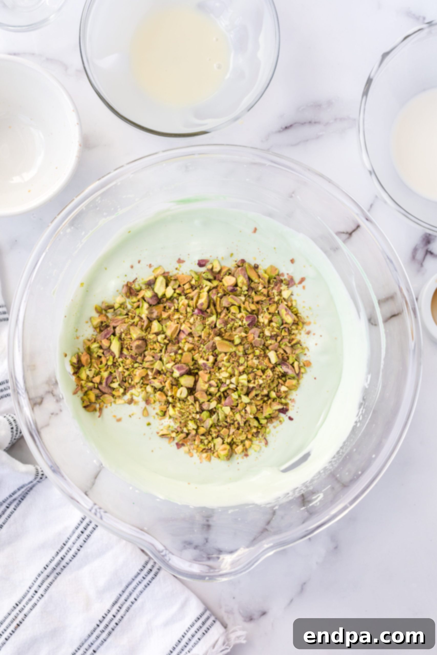 Emerald Dream Ice Cream 6 Pistachios added to bowl.
