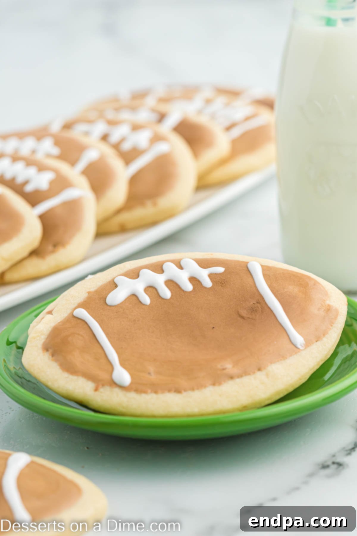 Touchdown Sugar Cookies 2 Football sugar cookies expertly decorated and lined up on a platter, ready for a game day celebration.