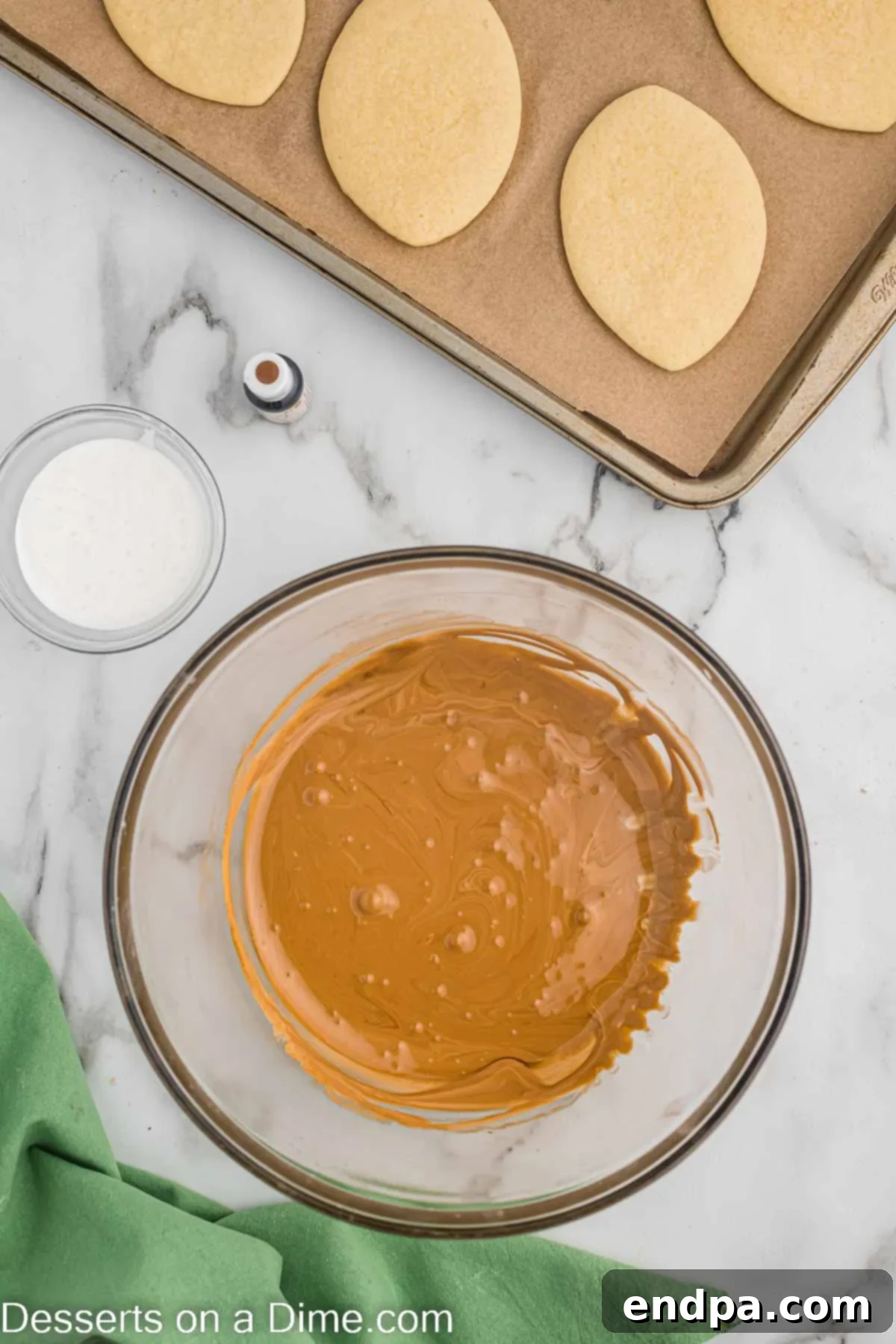 Touchdown Sugar Cookies 12 A small bowl with a portion of royal icing being mixed with brown gel food coloring to achieve a dark brown shade.