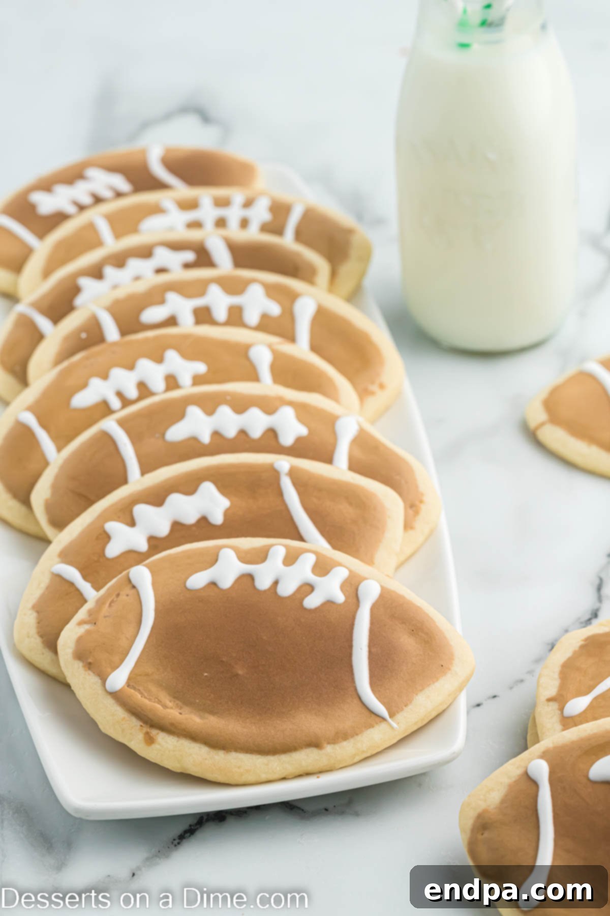 Touchdown Sugar Cookies 15 An inviting platter filled with beautifully decorated football sugar cookies, ready to be served at a game day party.