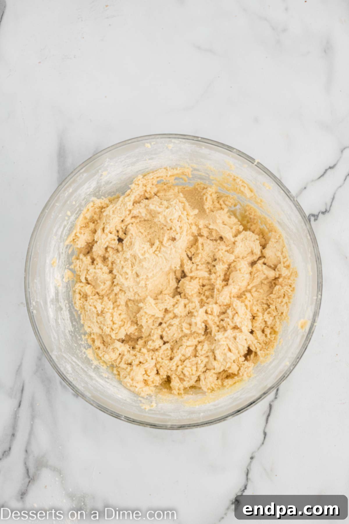 Touchdown Sugar Cookies 8 Dry ingredients, including flour, baking powder, and salt, being mixed into the wet cookie dough mixture.