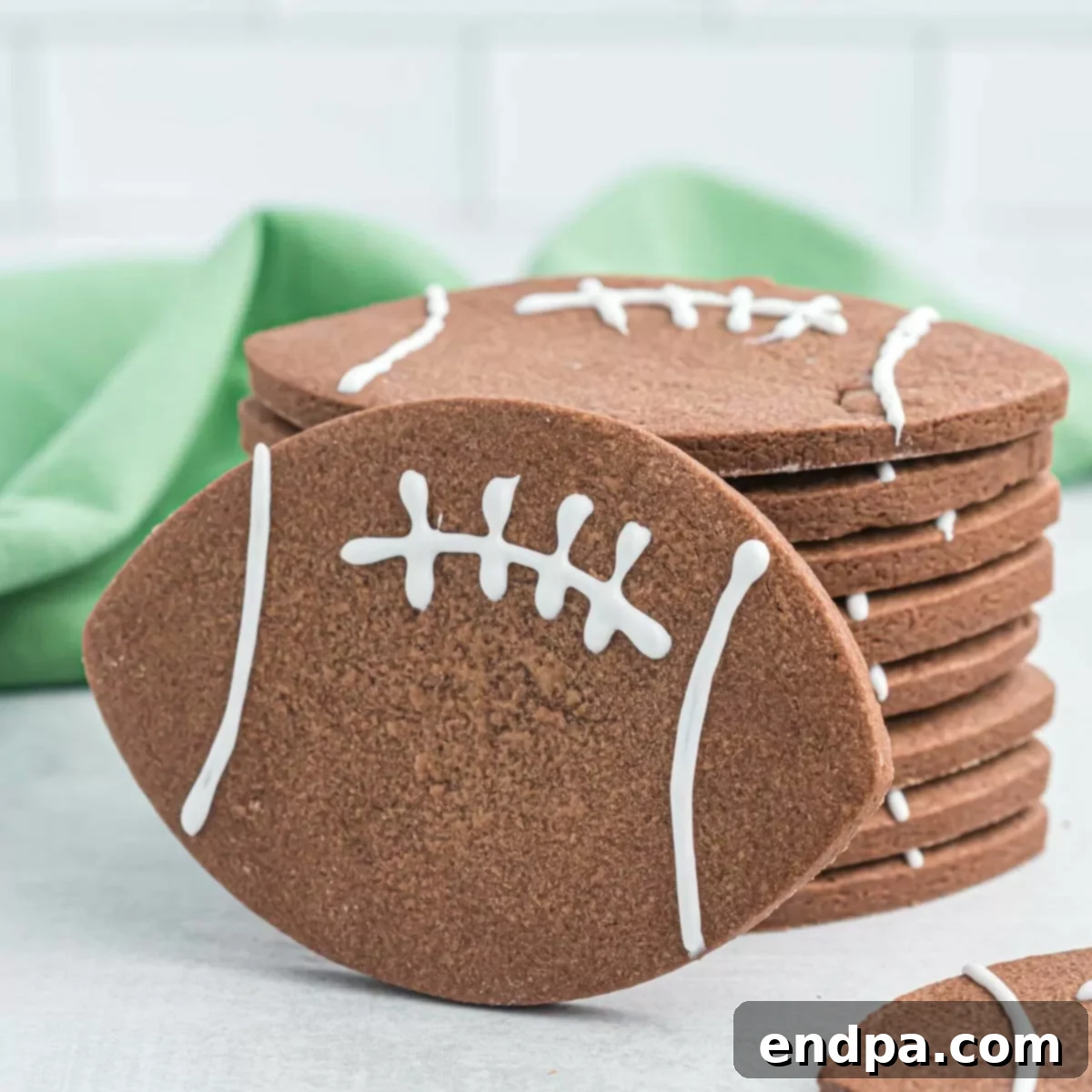 Championship Chocolate Football Cookies 13 Delicious chocolate football cookies with white icing details, ready to eat.