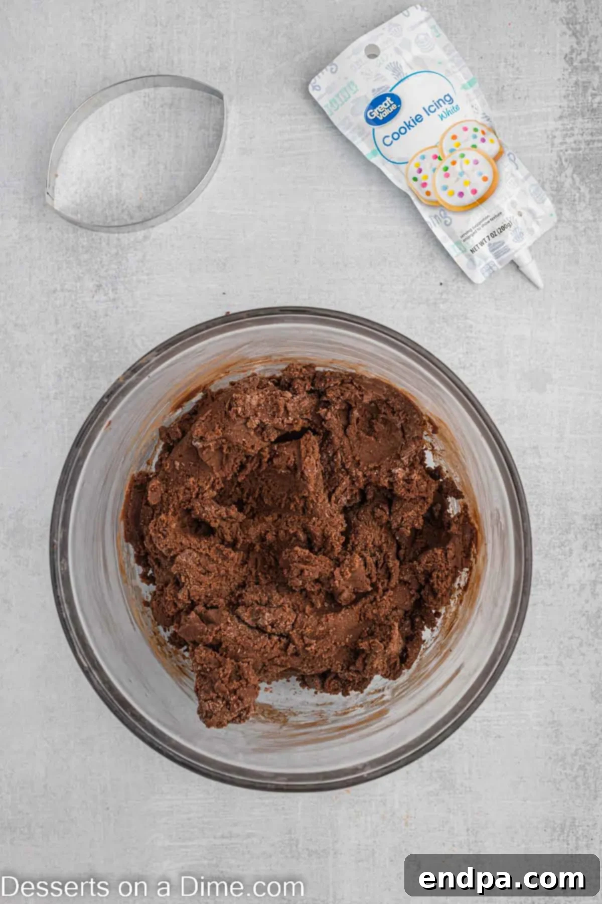 Championship Chocolate Football Cookies 6 Flour mixture being gradually added to the wet ingredients in a mixing bowl.