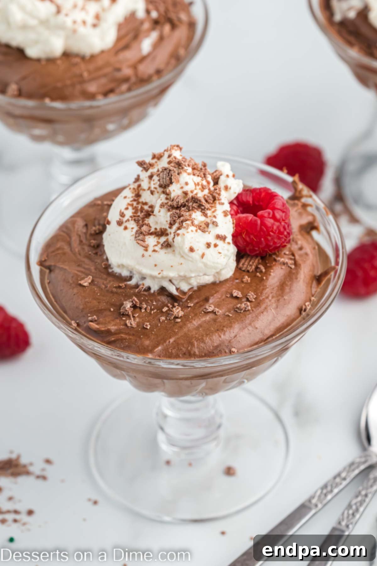 Velvety Chocolate Bliss 2 A bowl of rich chocolate mousse topped with fresh whipped cream and chocolate shavings, ready to be served.