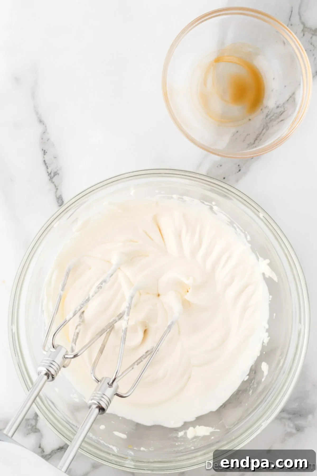 Velvety Chocolate Bliss 15 Fluffy, stiff peaks of whipped cream, indicating it's perfectly beaten and ready for the chocolate mousse.