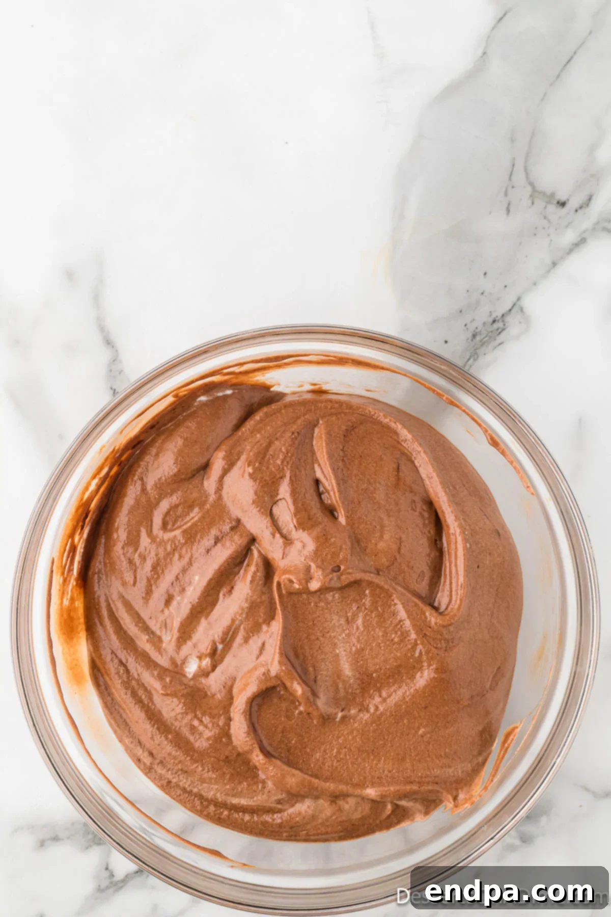 Velvety Chocolate Bliss 16 The airy whipped cream being carefully folded into the chocolate and egg mixture, creating the final mousse texture.