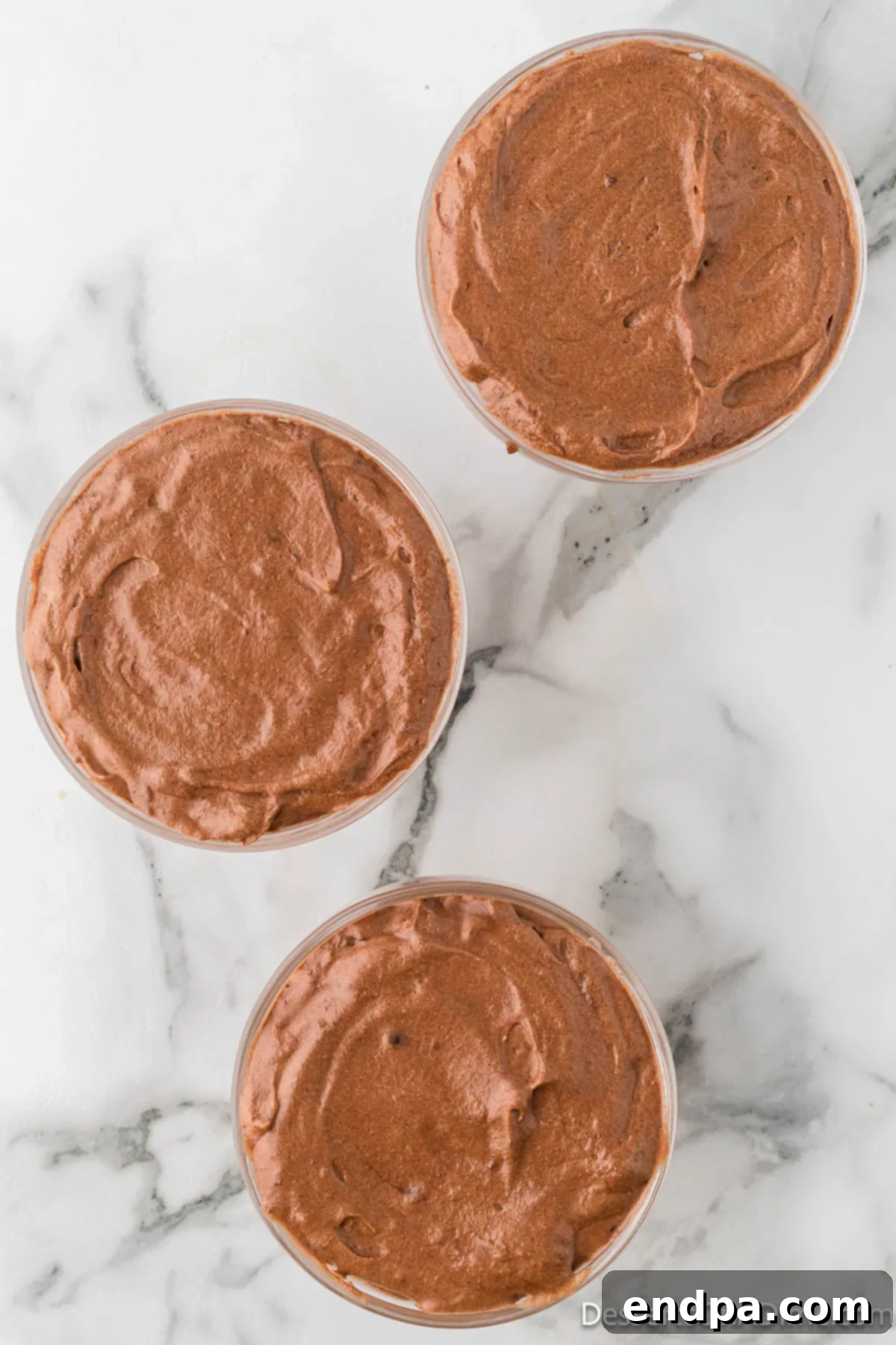 Velvety Chocolate Bliss 17 Six elegant serving bowls filled evenly with the freshly prepared, rich chocolate mousse, ready for chilling.