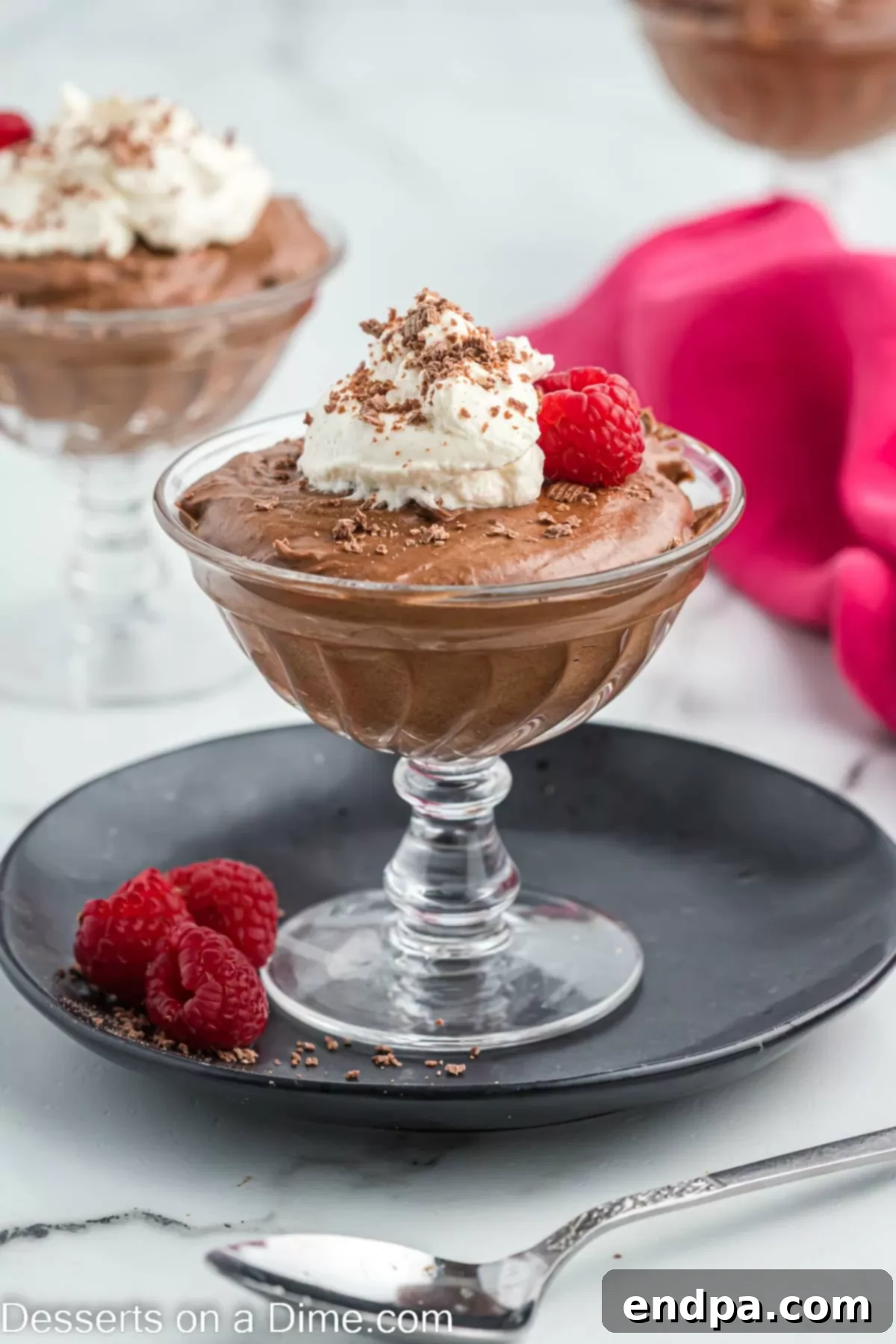 Velvety Chocolate Bliss 18 A close-up of a serving of chocolate mousse, showcasing its smooth texture, topped with a generous swirl of whipped cream and delicate chocolate shavings, ready for enjoyment.