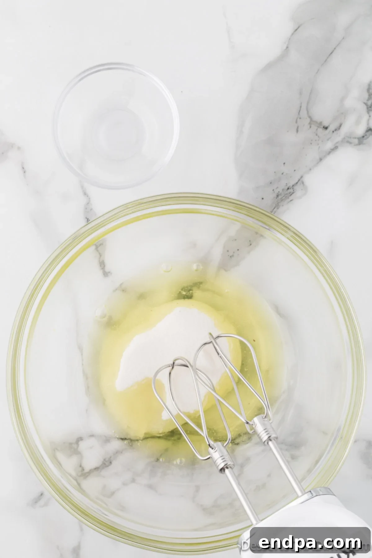 Velvety Chocolate Bliss 9 Egg whites and granulated sugar beginning to be beaten together in a large mixing bowl, showing initial frothy texture.