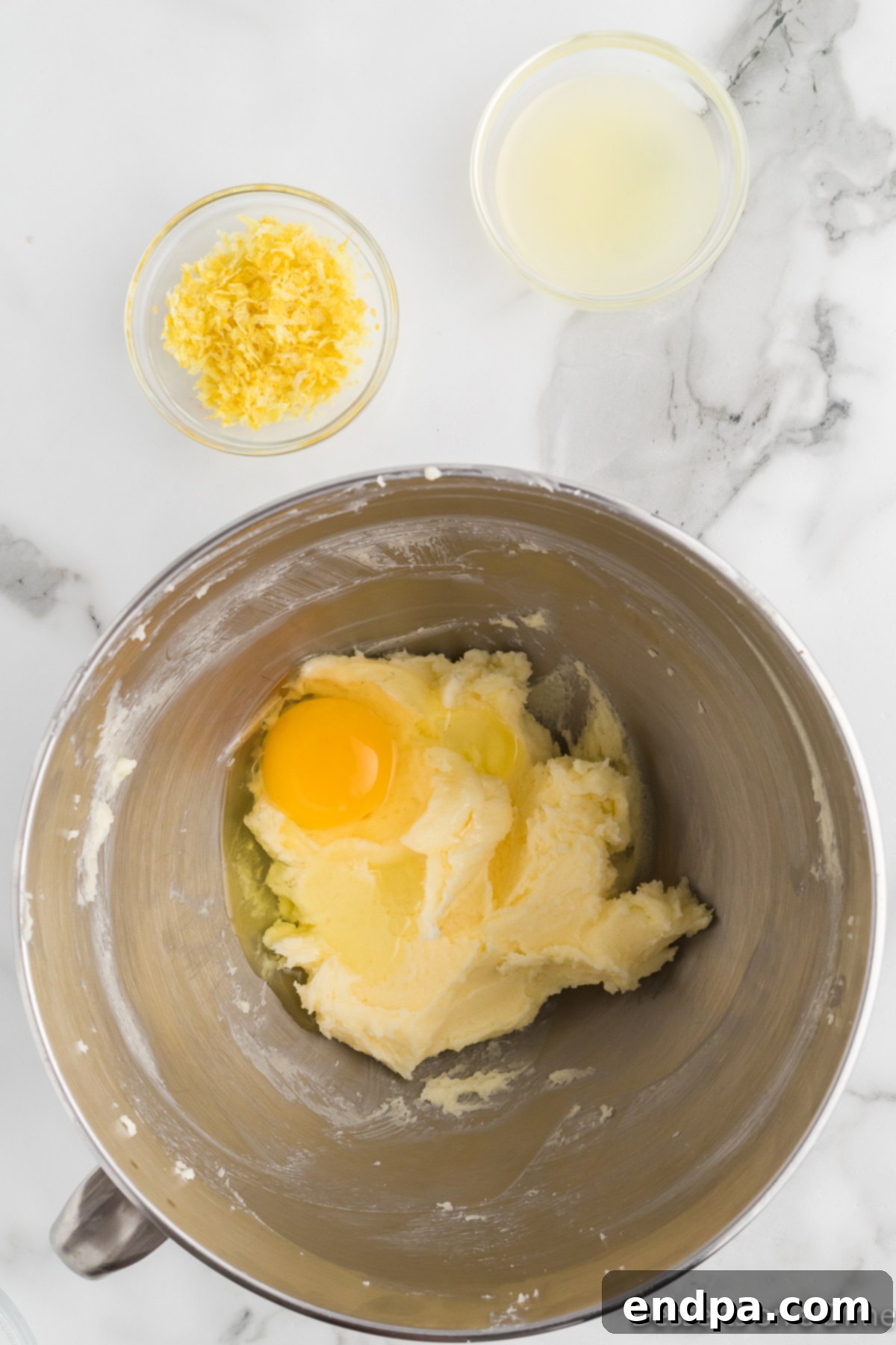 Egg, fresh lemon juice, and lemon zest added to the creamed butter and sugar mixture.