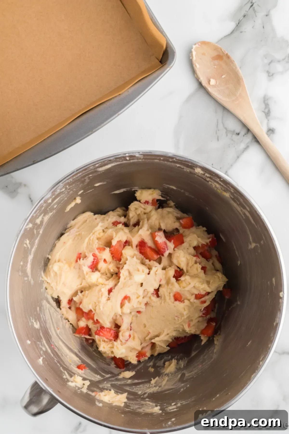 Diced fresh strawberries and white chocolate chips gently folded into the blondie batter.