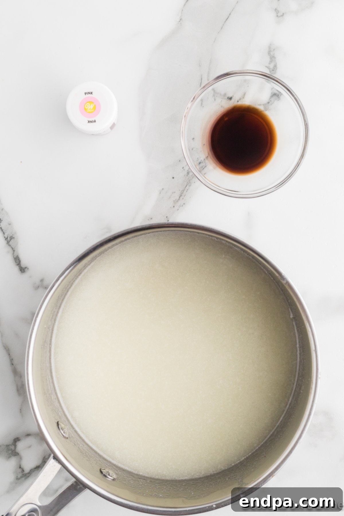 The sugar mixture combined and heated in a saucepan, showing its smooth, glossy consistency before coloring.