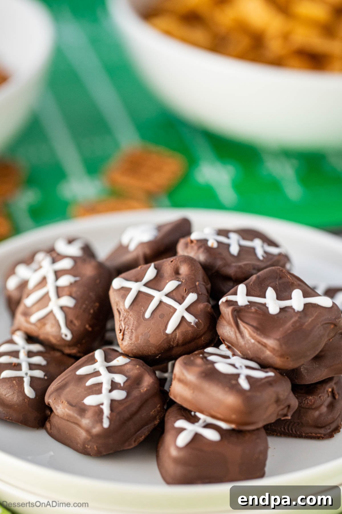 Chocolate Covered Pretzel Cookies on a platter, shaped like mini footballs.