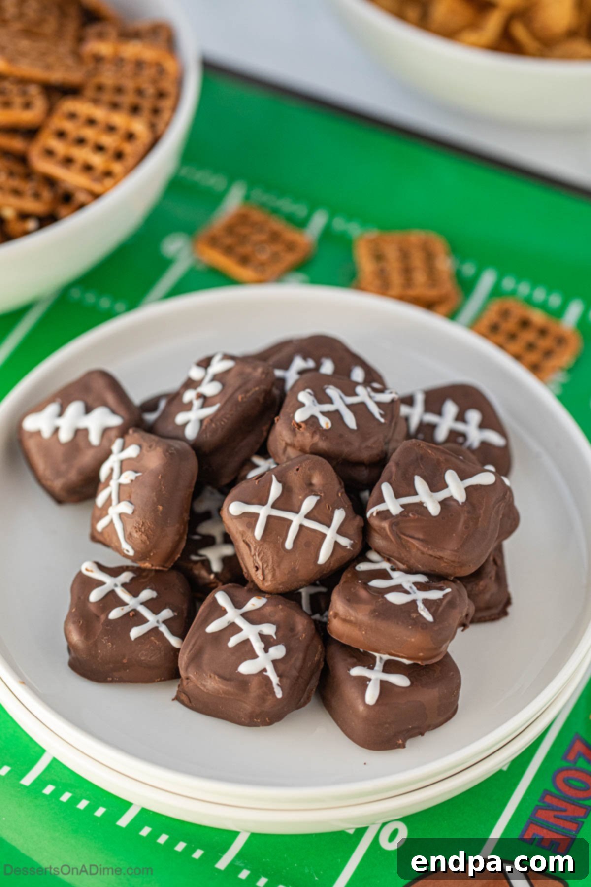 A close-up of Chocolate Covered Pretzel Cookies on a platter, showing the football lace detail.