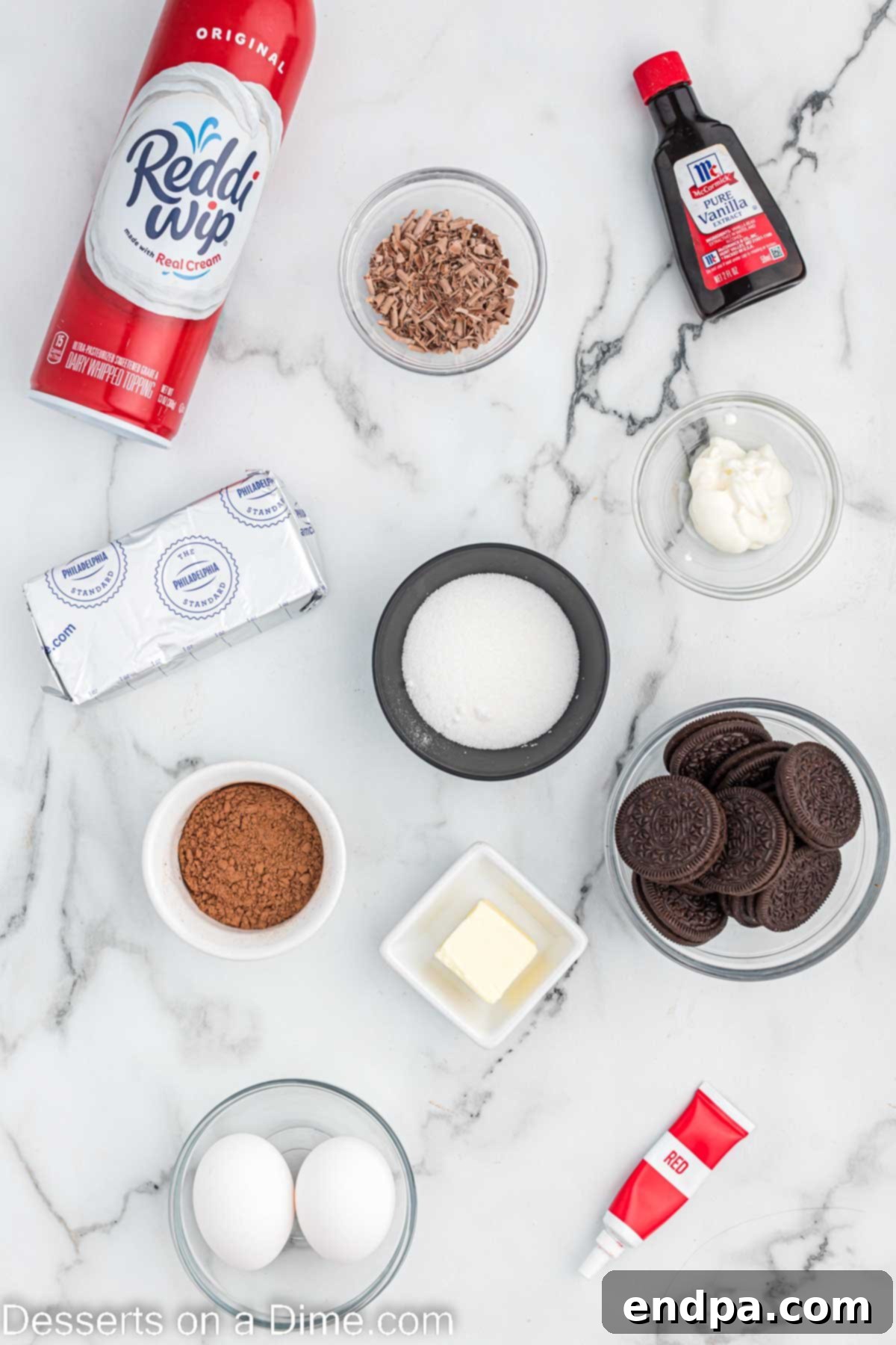 Petite Red Velvet Cheesecakes 3 Ingredients for Mini red velvet cheesecake - oreo cookies, butter, cream cheese, sour cream, cocoa powder, vanilla, red food coloring, whipped cream, chocolate shavings.