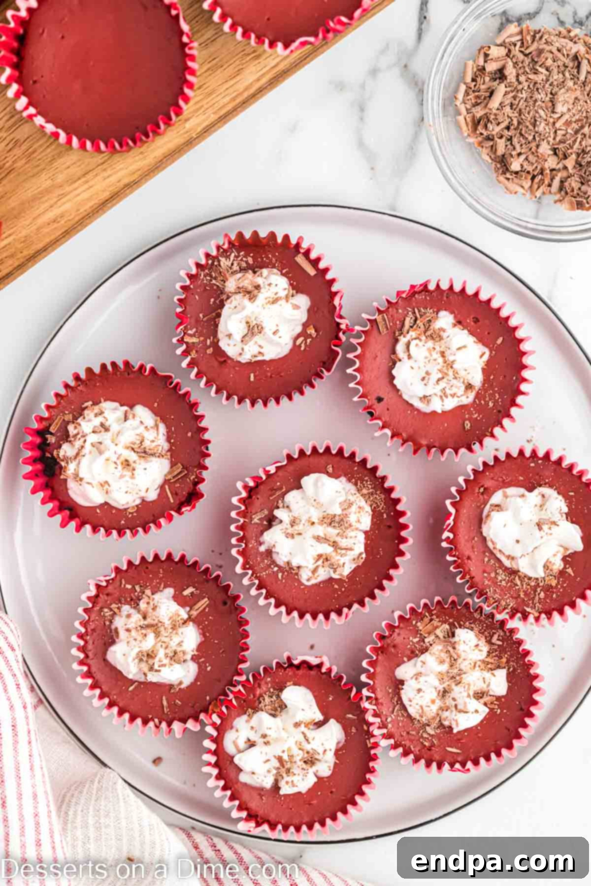 Petite Red Velvet Cheesecakes 9 Cheesecake topped with cool whip.