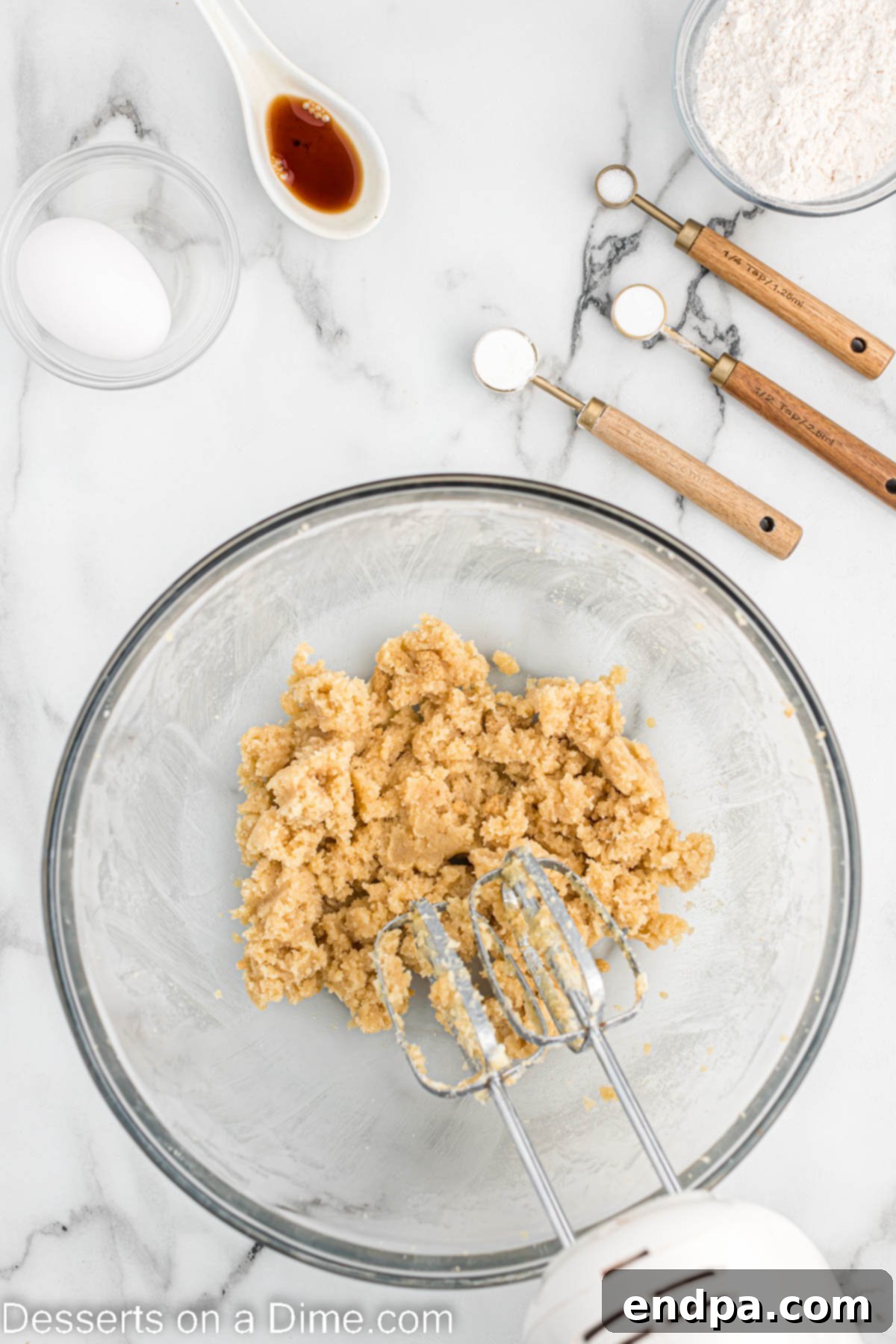 A mixing bowl showing butter and sugar creamed together, forming a light and fluffy mixture.