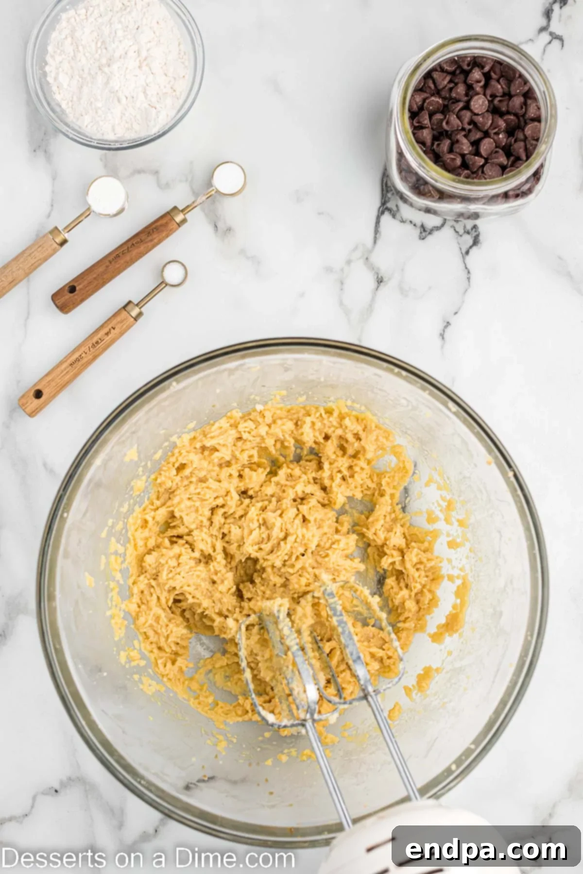A mixing bowl with eggs and vanilla extract incorporated into the creamed butter and sugar mixture.