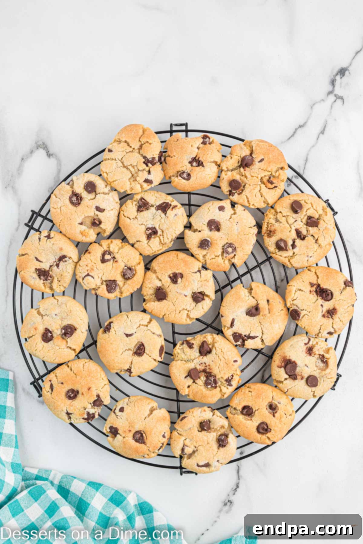 Warm air fryer chocolate chip cookies cooling on a wire rack after being removed from the air fryer.
