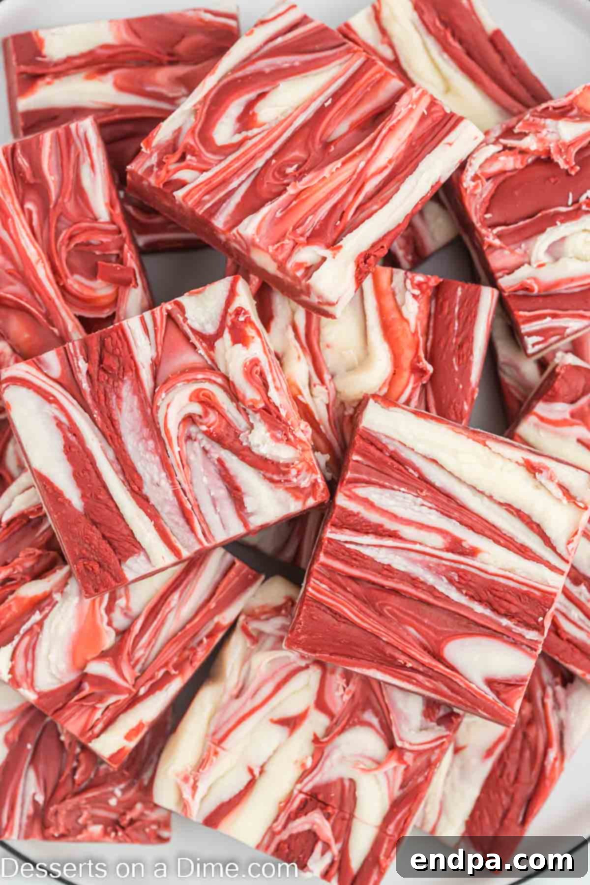 Another enticing stack of red velvet fudge squares, highlighting the rich red color and intricate swirls.