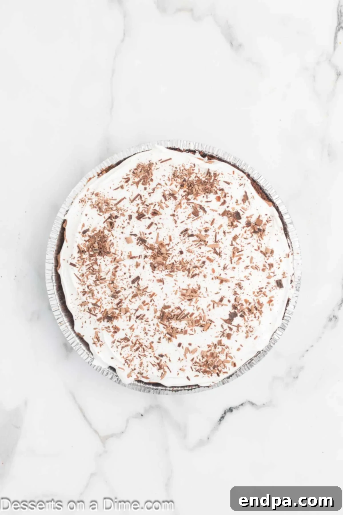 Decadent Chocolate Mousse Delight 7 A finished chocolate mousse pie topped with generous swirls of whipped cream and delicate chocolate shavings.