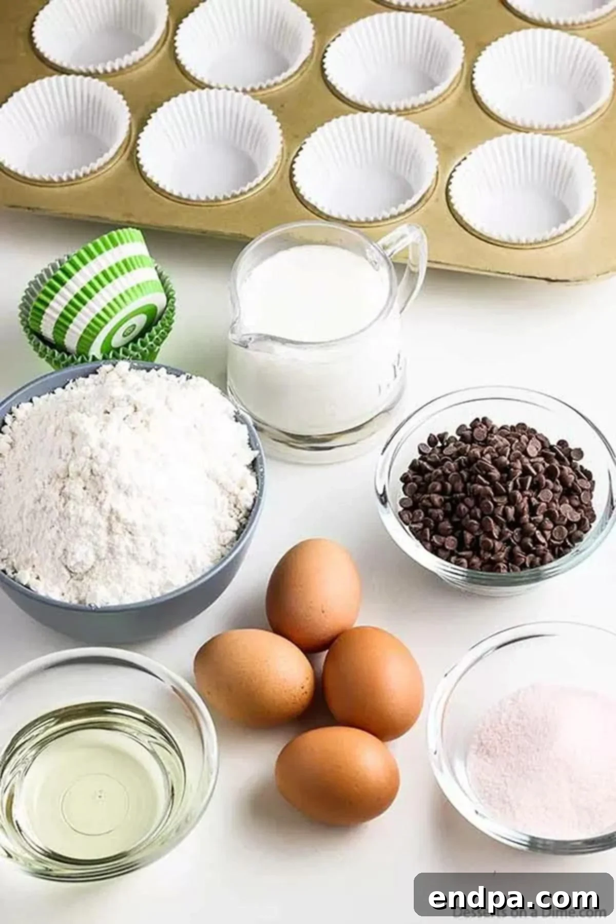Simple ingredients for a spectacular summer dessert! Ingredients needed for watermelon cupcakes: white cake mix, watermelon jello, milk, oil, eggs, pink food coloring, mini chocolate chips, and frosting.