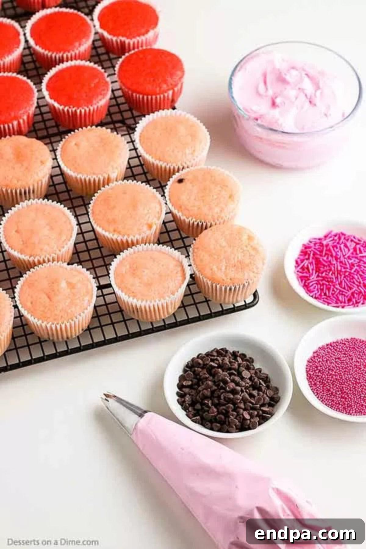 Watermelon Splash Cupcakes 5 Freshly baked watermelon cupcakes cooling on a wire rack.