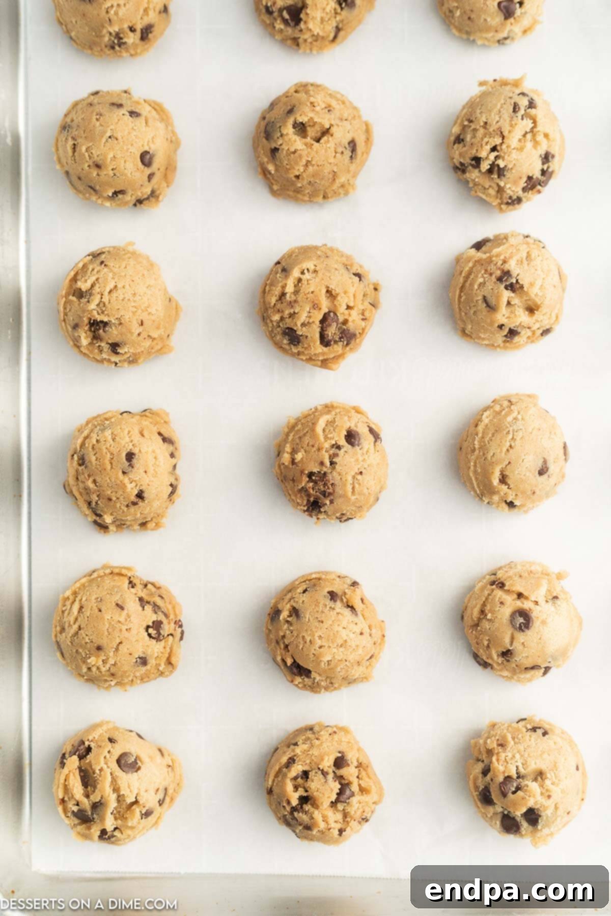 Effortless Cookie Prep: Freezing Dough for Later 4 Close-up shot of perfectly portioned cookie dough balls on a baking sheet, ready for the freezer.