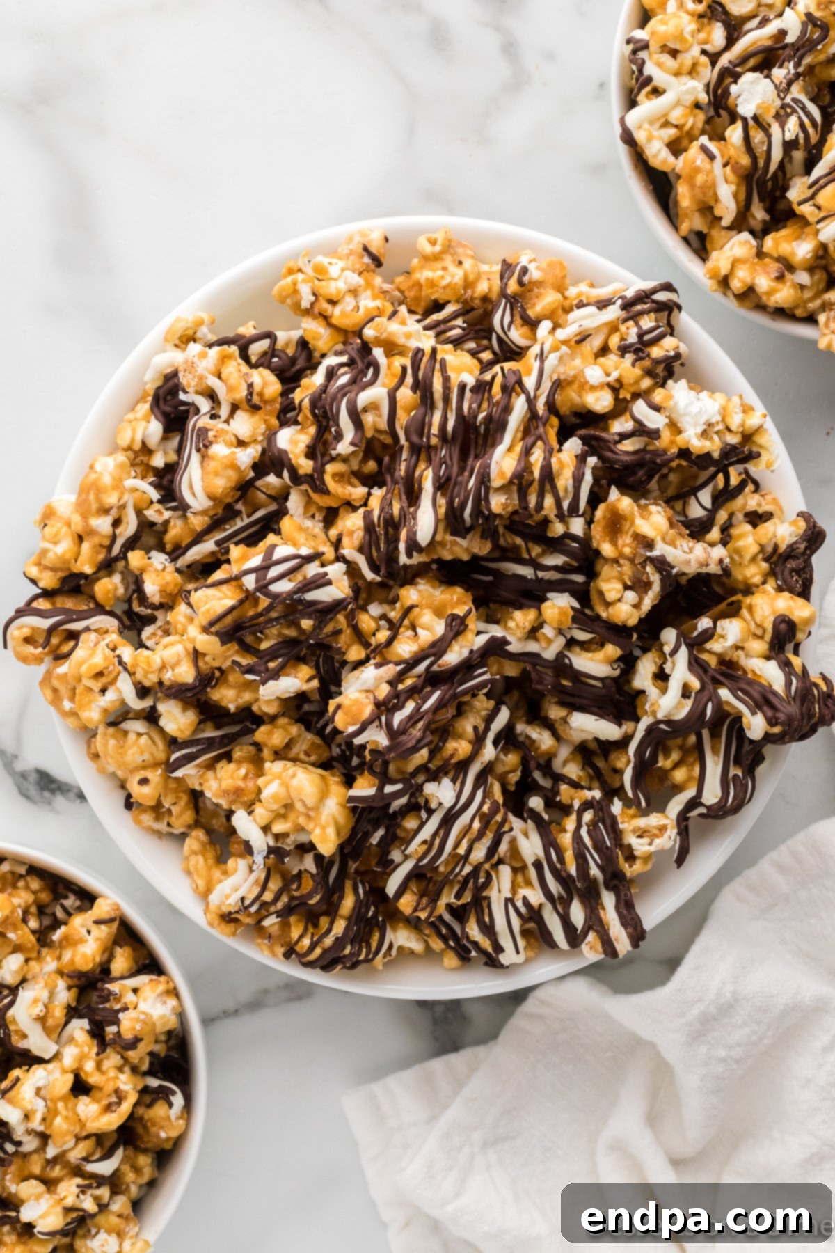 A beautifully arranged bowl of Zebra popcorn, showcasing its distinct white and dark chocolate stripes.