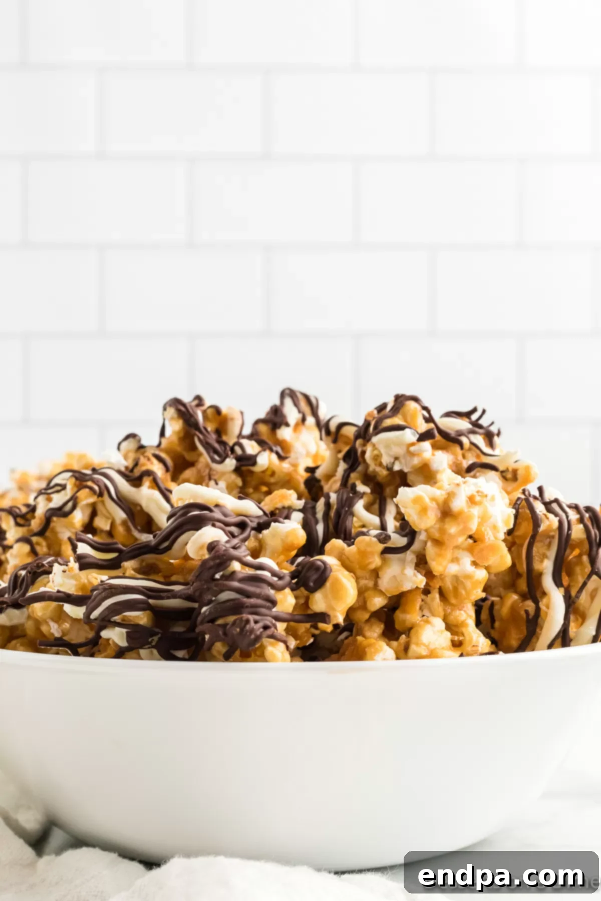 A generous serving of Zebra popcorn in a rustic bowl, showcasing its delicious layers and distinct stripes.