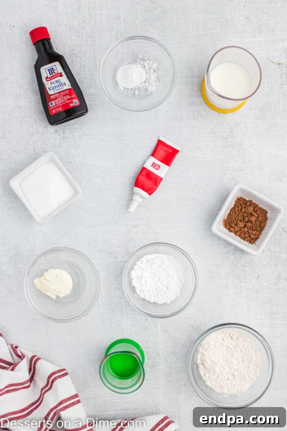 Ingredients needed for Red Velvet Mug Cake: flour, sugar, cocoa powder, baking powder, milk, oil, vanilla extract, red food coloring, cream cheese, powdered sugar