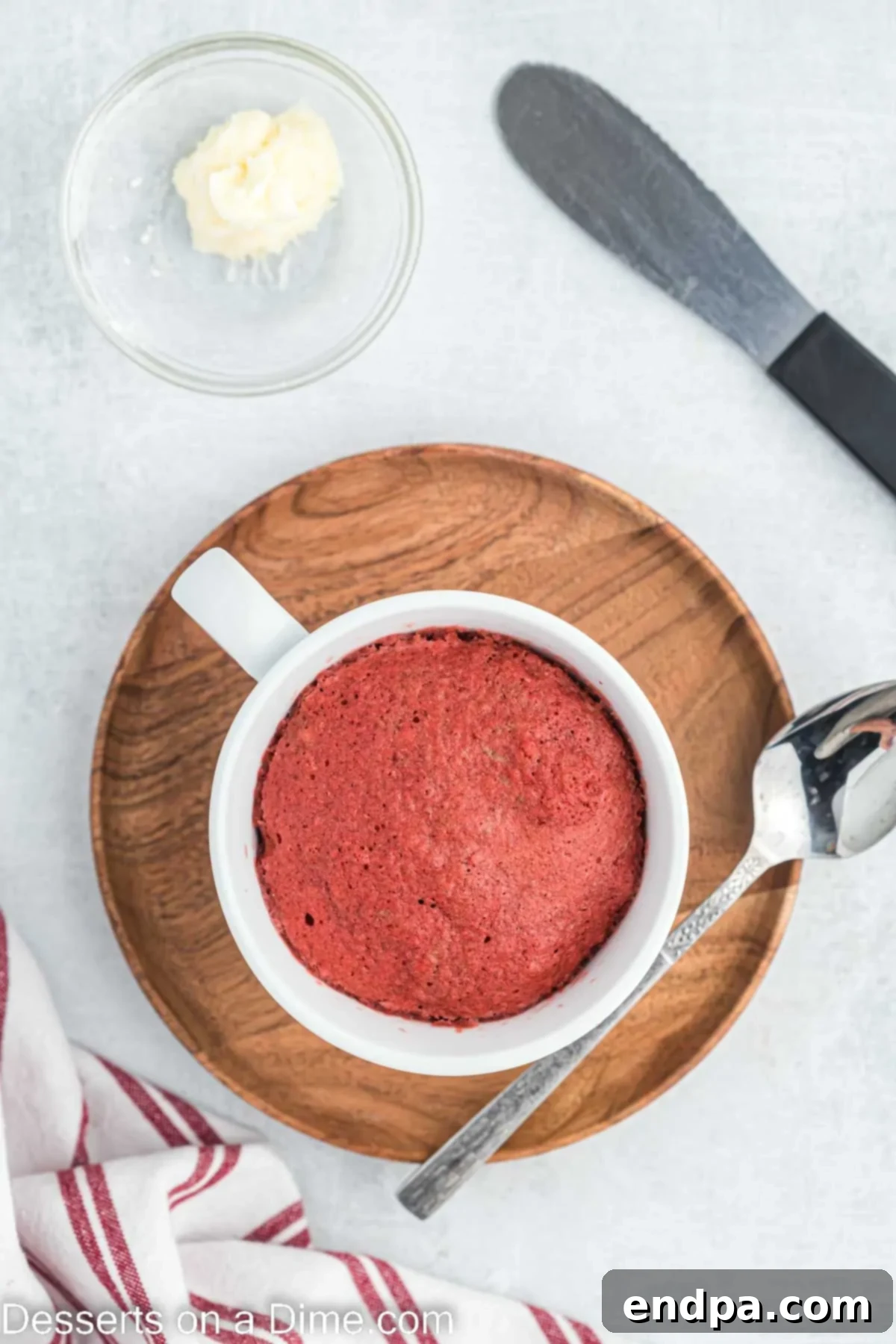 Mug cake cooked in the microwave, cooled slightly, and ready for frosting