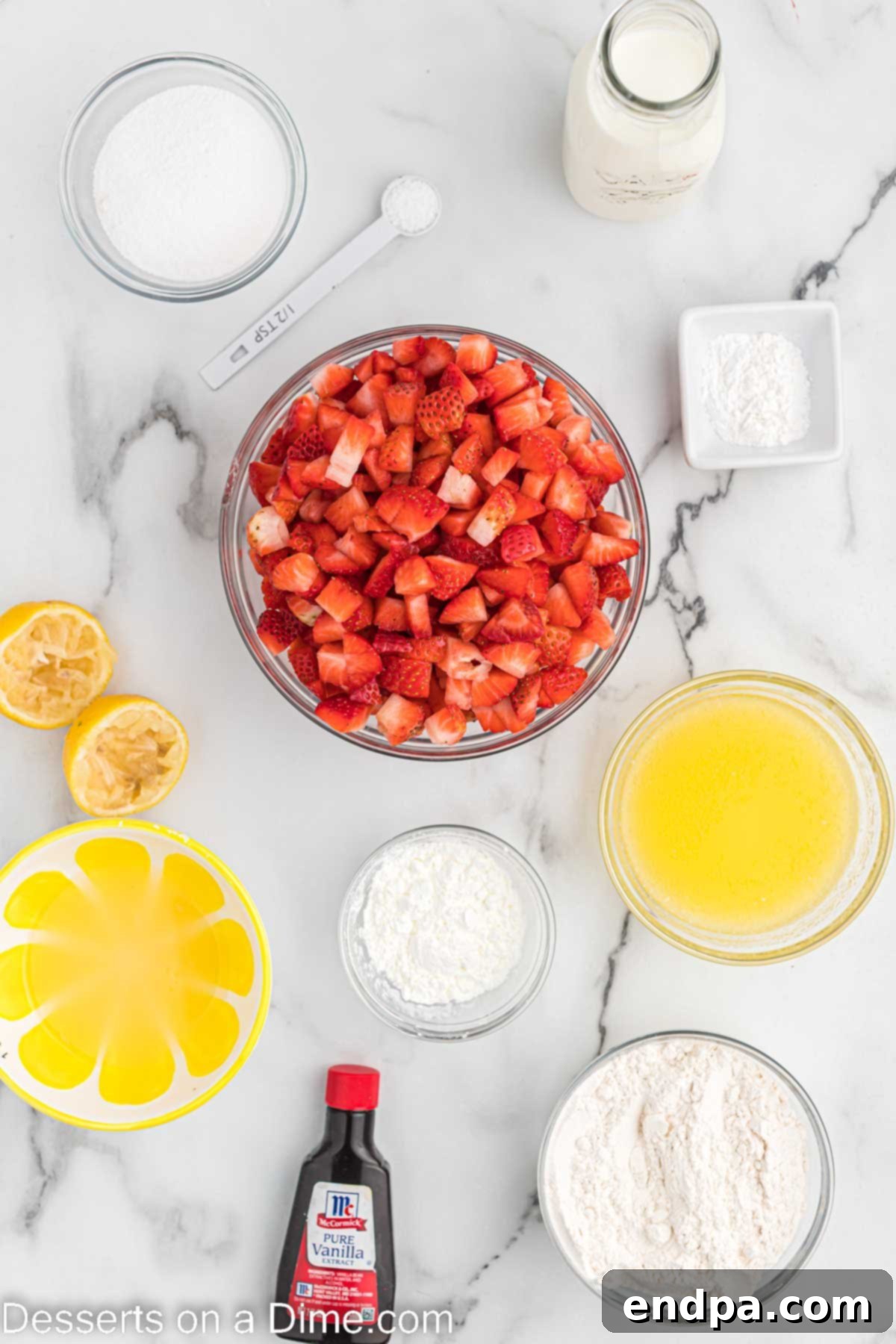 Ingredients for Strawberry cobbler - Fresh strawberries, sugar, lemon, cornstarch, flour, butter, salt, baking powder, milk, vanilla extract