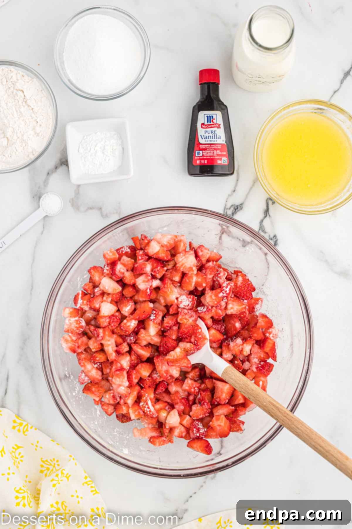 Combining the strawberries in a bowl with wooden spoon