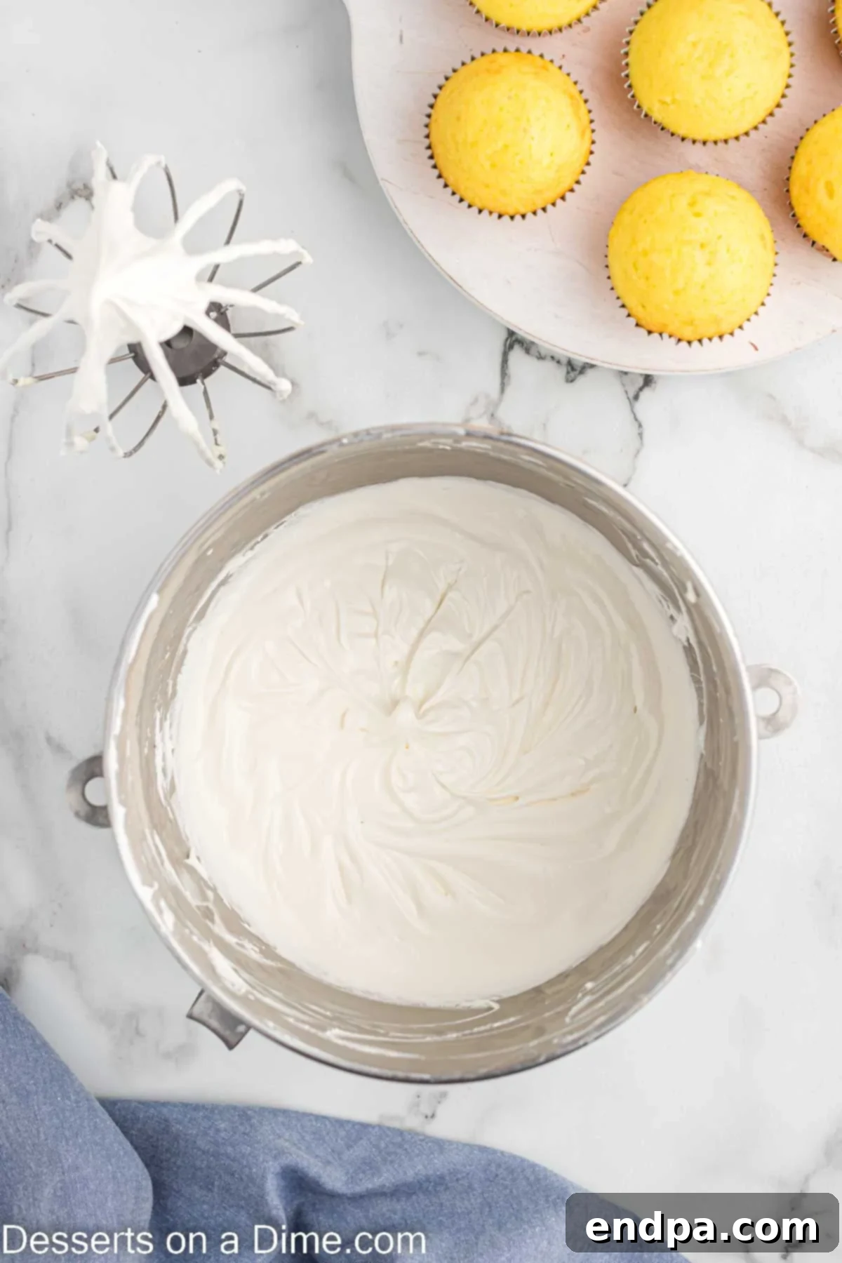 Whipped topping being gently folded into the cream cheese mixture until well blended.