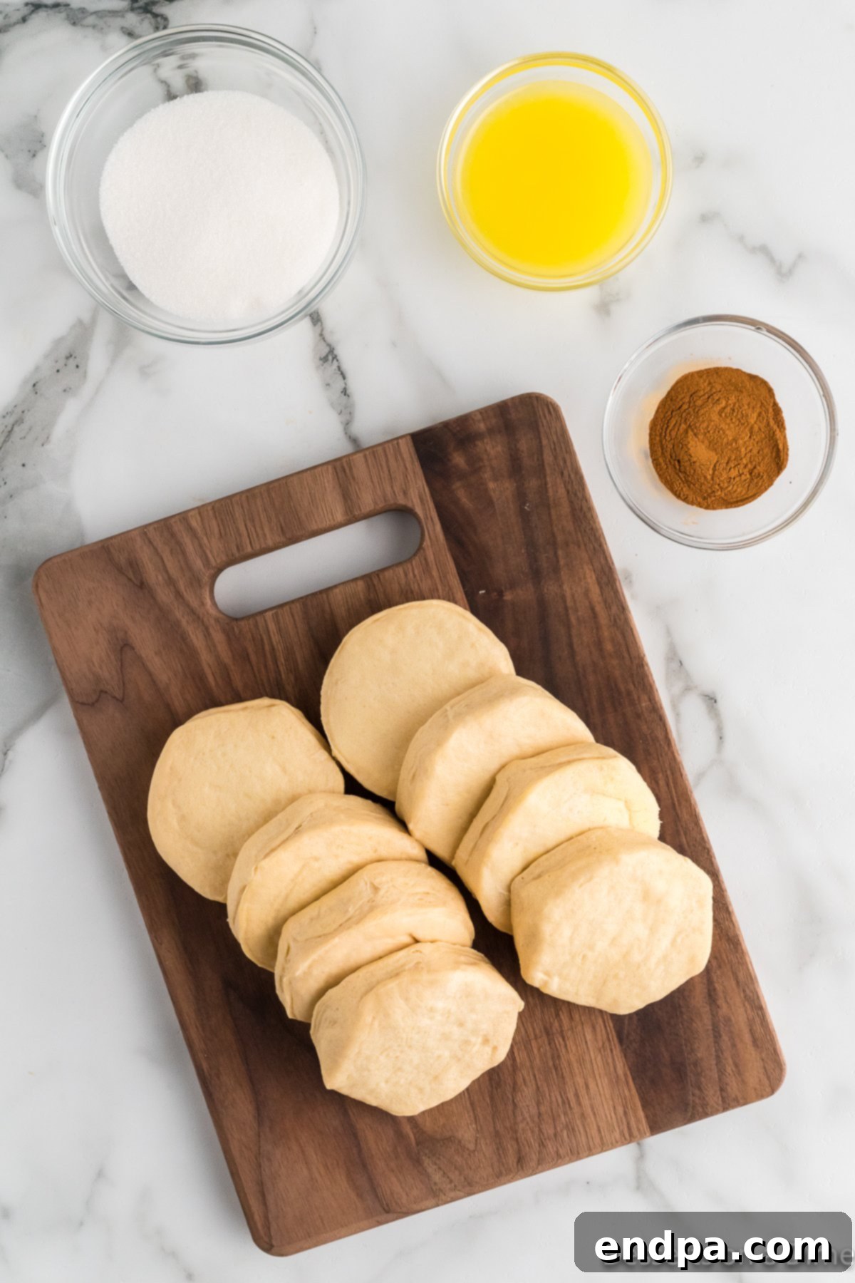 Air Fryer Donut Poppers 3 Ingredients for Air fryer donut holes: refrigerated biscuits, granulated sugar, ground cinnamon, and melted butter.