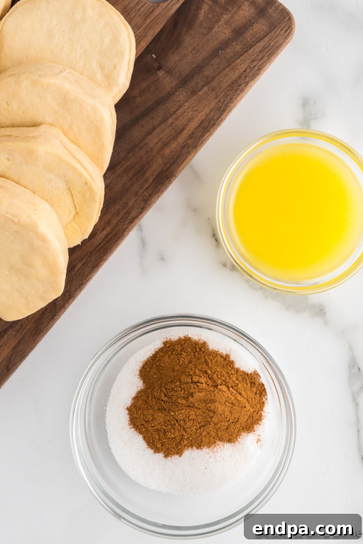 Air Fryer Donut Poppers 7 A bowl containing a mixture of cinnamon and granulated sugar.