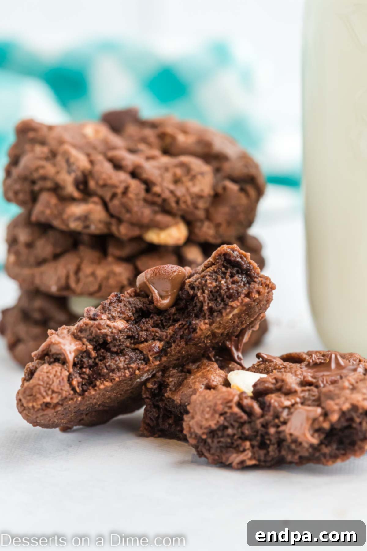A stack of perfectly baked triple chocolate cookies, rich and gooey.