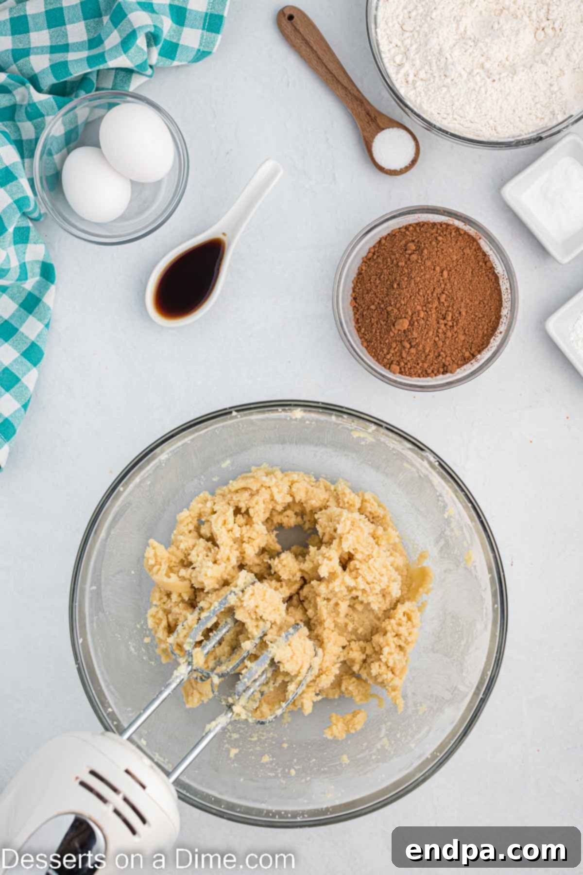 Softened butter and sugars being creamed together in a mixing bowl.