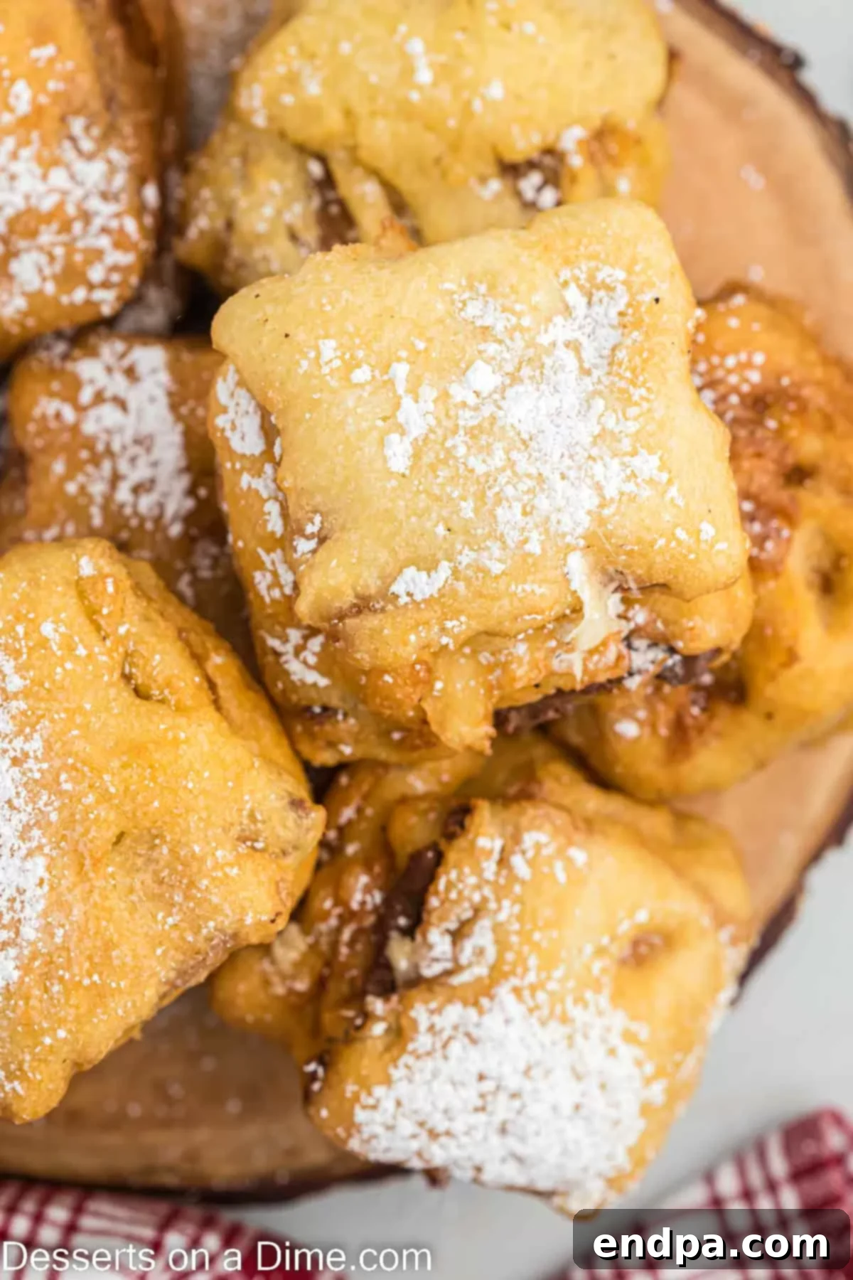 Crispy Golden Smores Delight 8 A stack of golden-brown Deep Fried S'mores on a platter, elegantly dusted with powdered sugar.