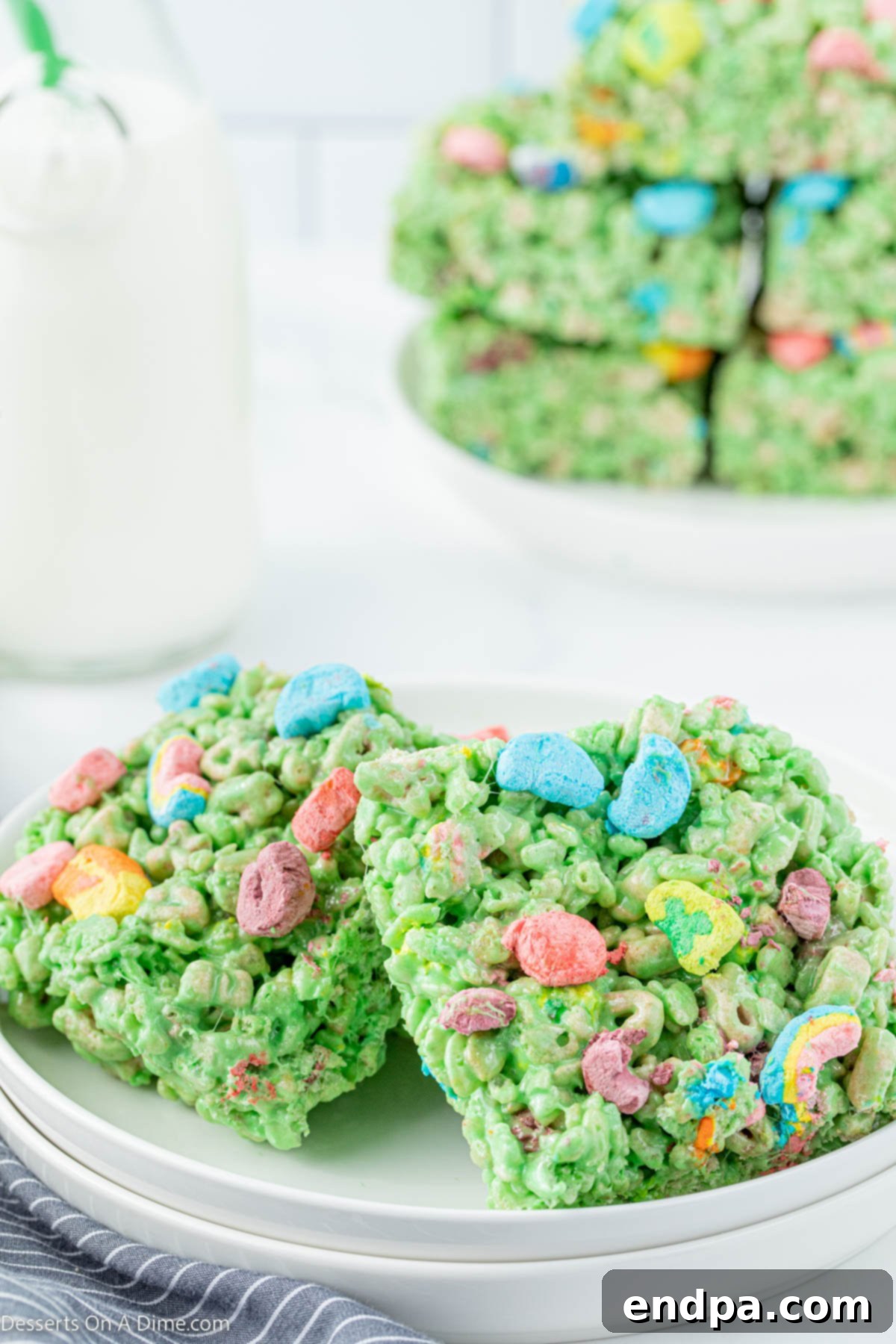 Shamrock Krispie Squares 2 Green St. Patrick's Day Rice Krispie treats, studded with Lucky Charms marshmallows, neatly cut into squares and ready to serve.
