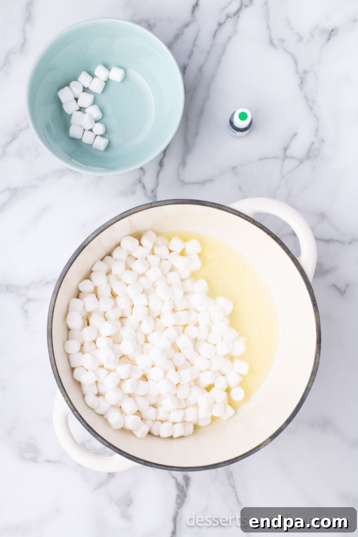 Shamrock Krispie Squares 4 Butter and mini marshmallows melting in a large pot on the stove.