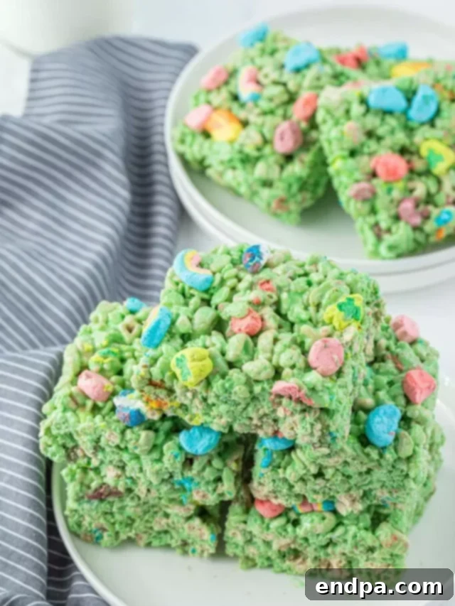 Shamrock Krispie Squares 9 Squares of St. Patrick's Day Lucky Charms Rice Krispie treats arranged on a festive platter.