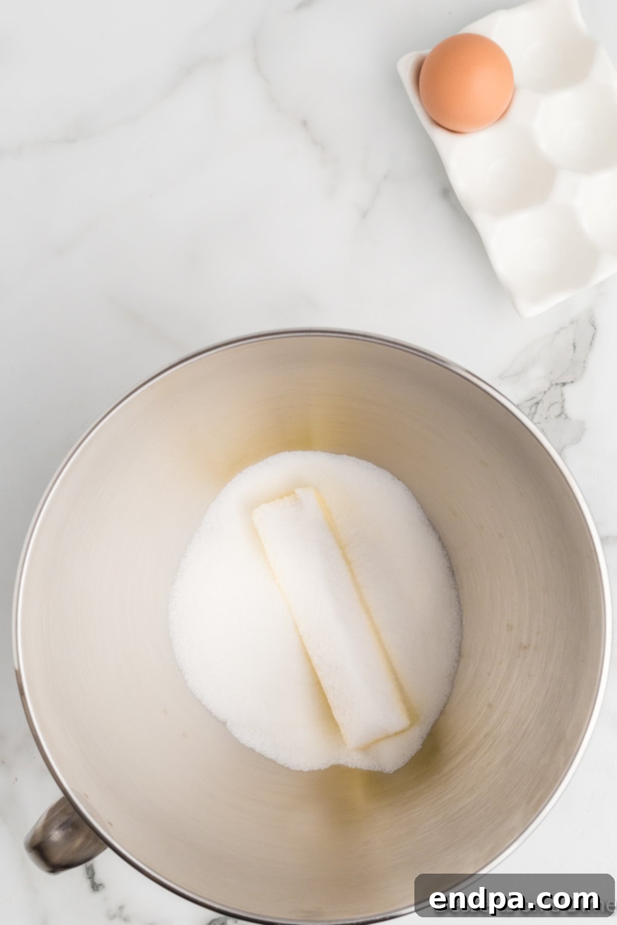 Butter and sugar creamed together in bowl. 