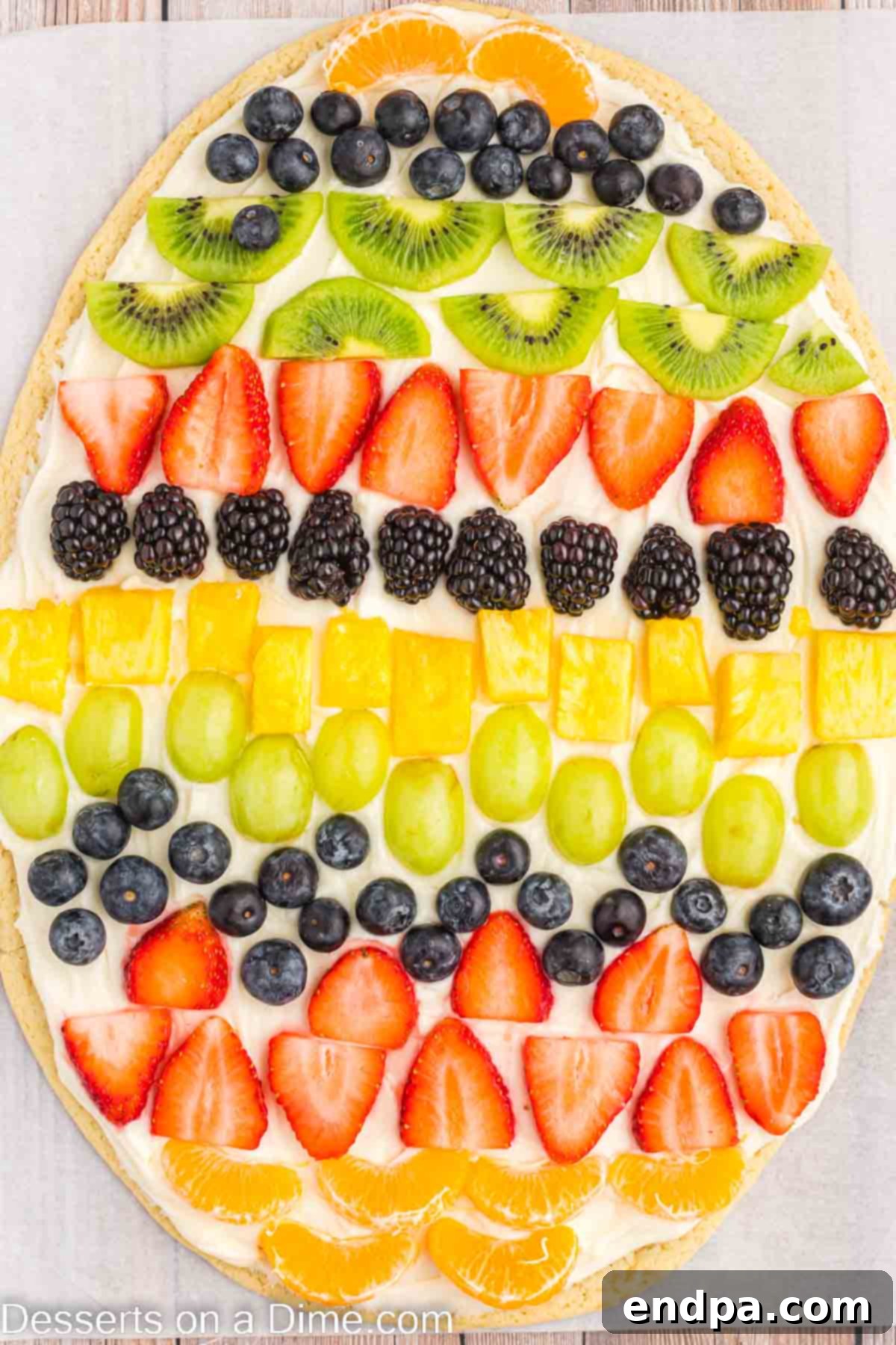 Beautifully decorated Easter Egg Fruit Pizza with various fresh fruits ready to serve on a festive platter.