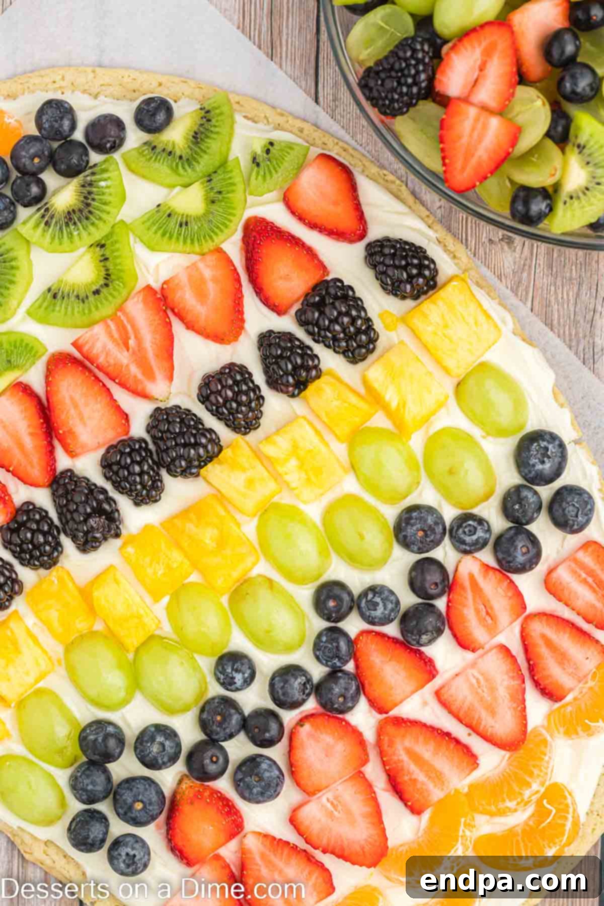 A finished Easter Egg Fruit Pizza, beautifully decorated with an assortment of colorful fresh fruits arranged in an appealing pattern.