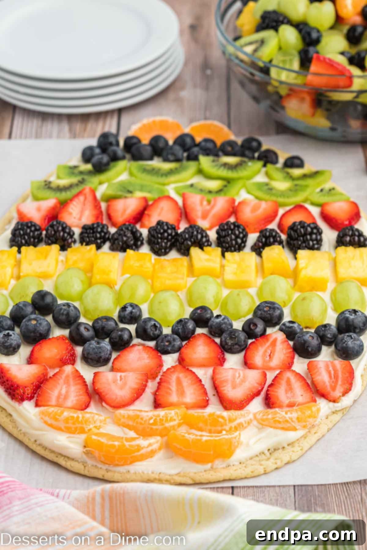Close-up of a vibrant Easter Egg Fruit Pizza, showcasing the variety and arrangement of fresh fruits on a creamy frosting base.