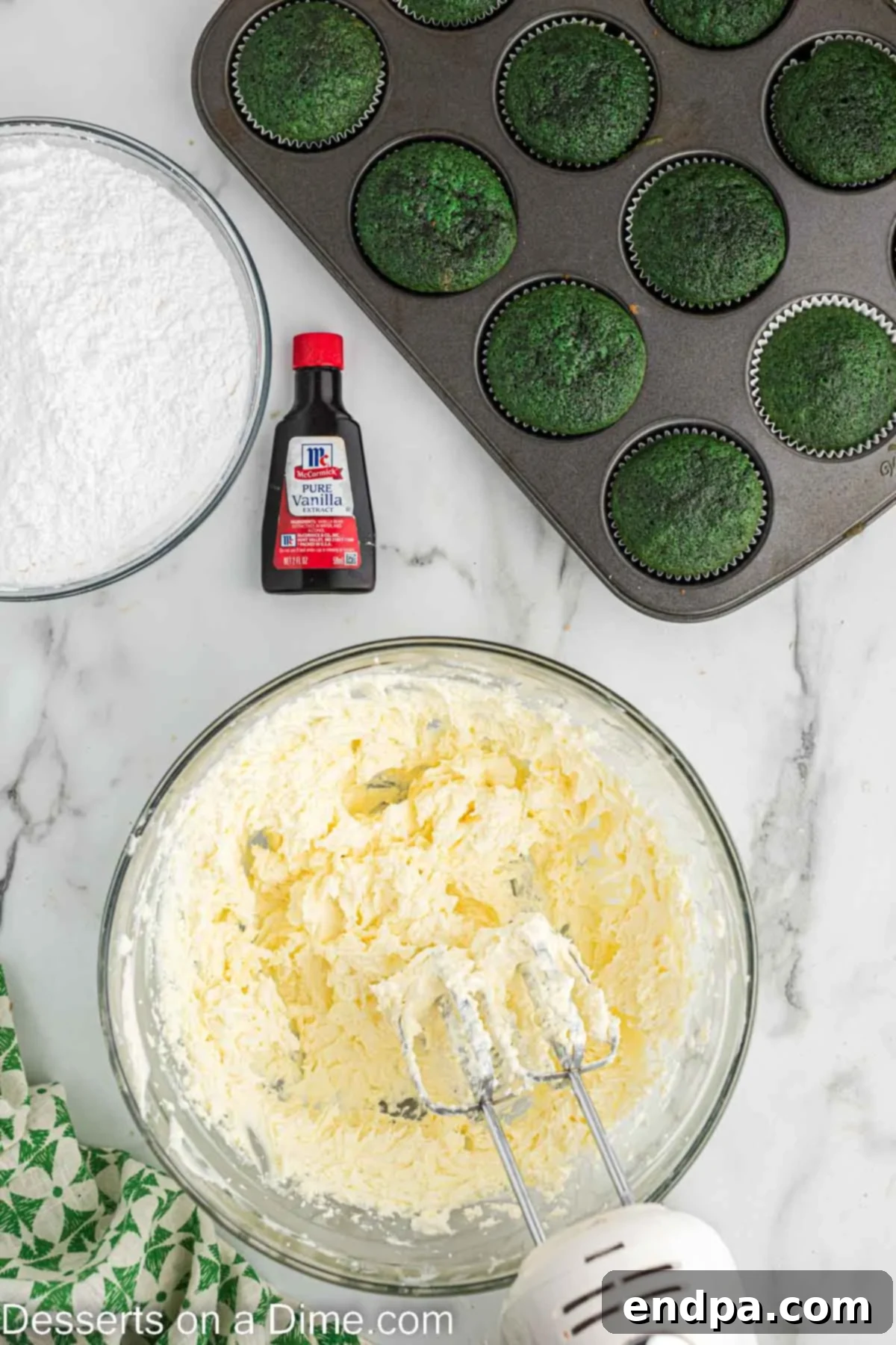A bowl of freshly made cream cheese frosting, smooth and ready for piping onto cupcakes.