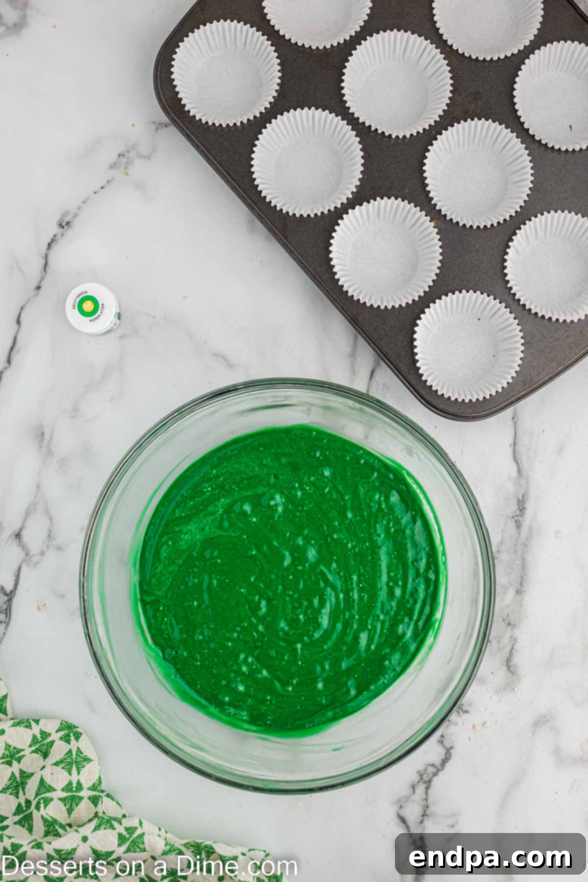 Fluffy egg whites gently folded into the green cupcake batter, adding lightness.